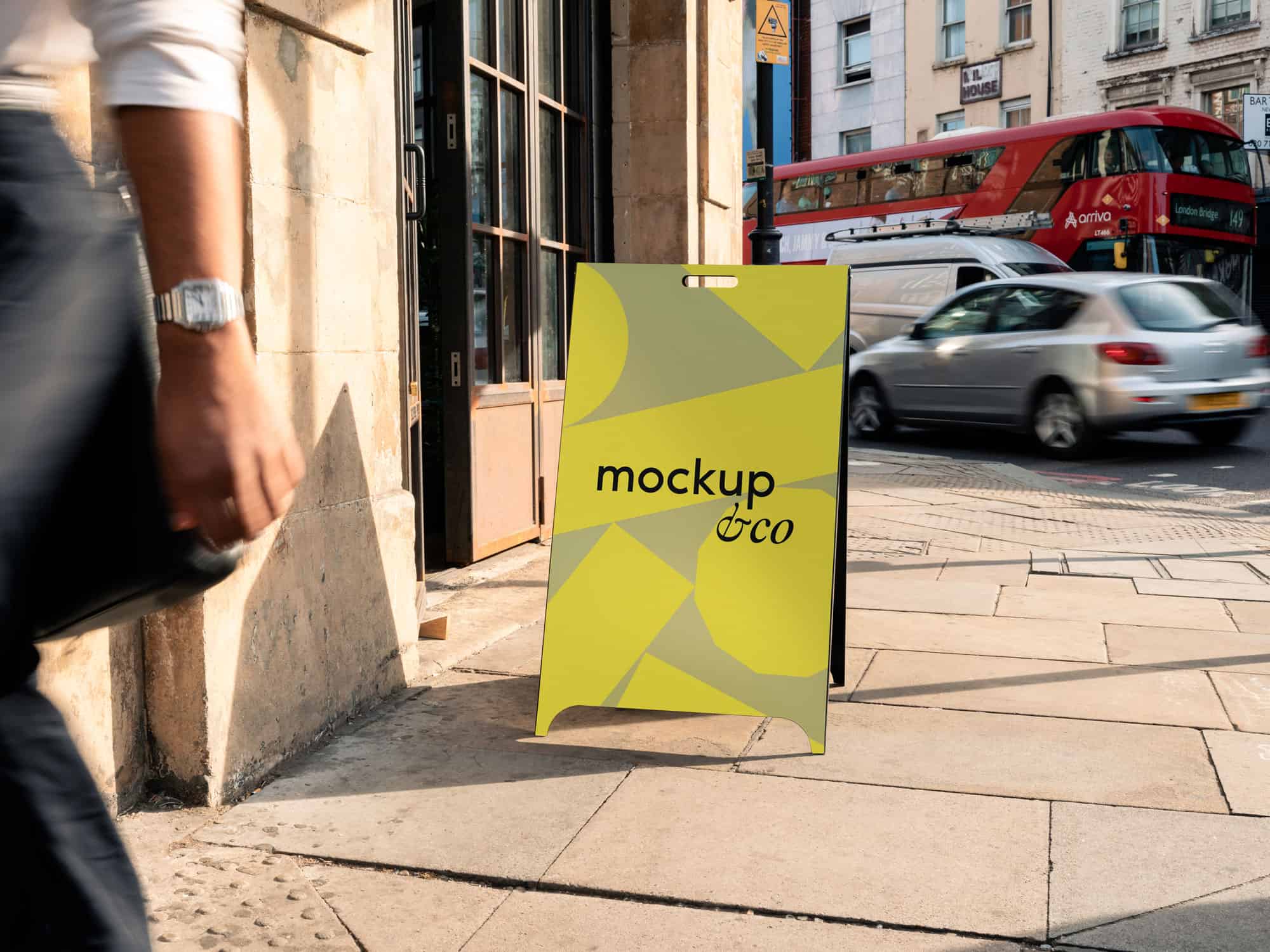 Free A-frame mockup featuring a customizable London background, perfect for showcasing designs in a city setting.