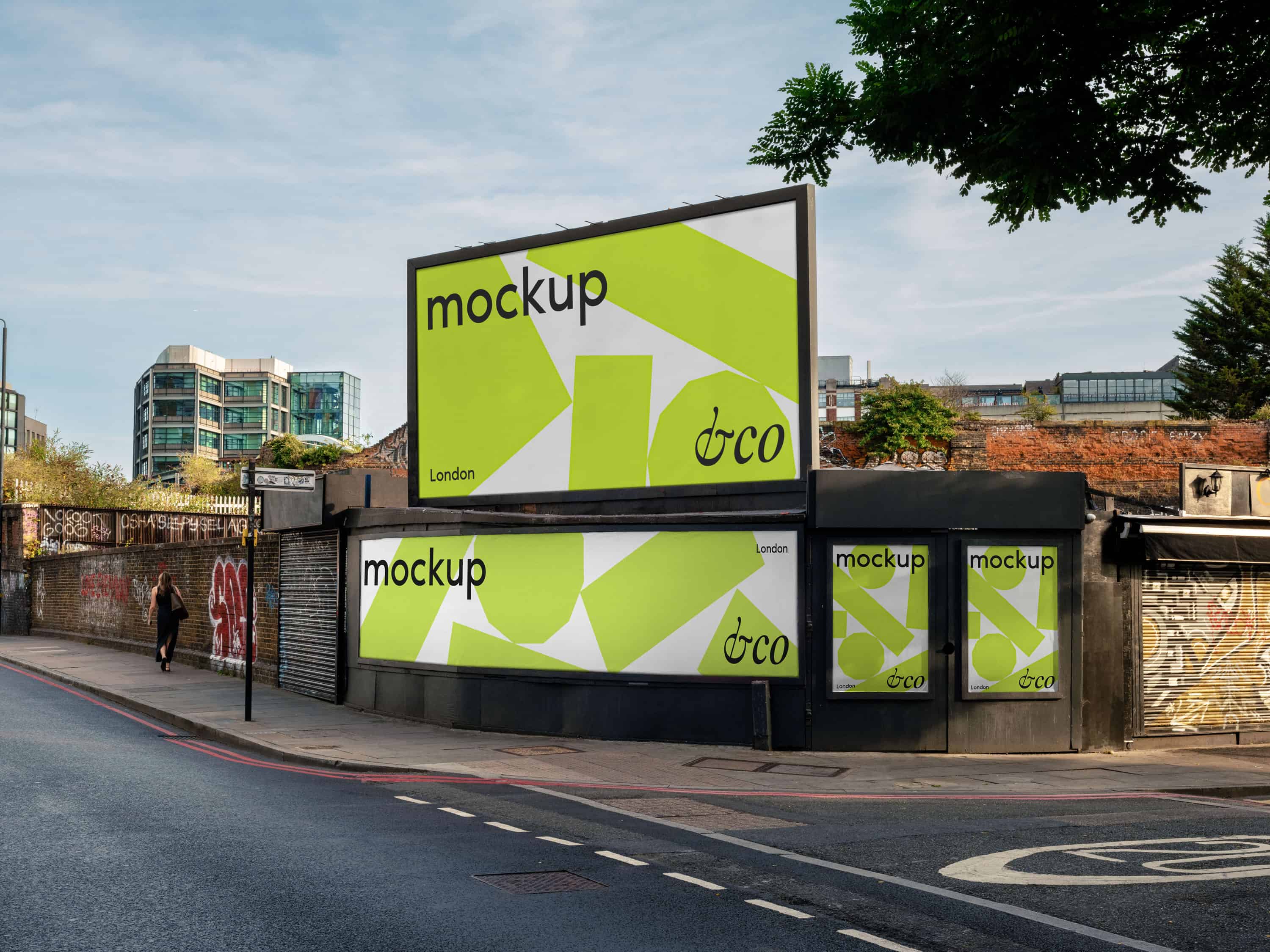 Street view in Hackney showcasing a mockup of four billboards, two landscape and two portrait, positioned at the corner of the intersection with potential advertising displays.
